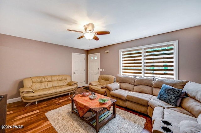 living room with ceiling fan and dark hardwood / wood-style flooring