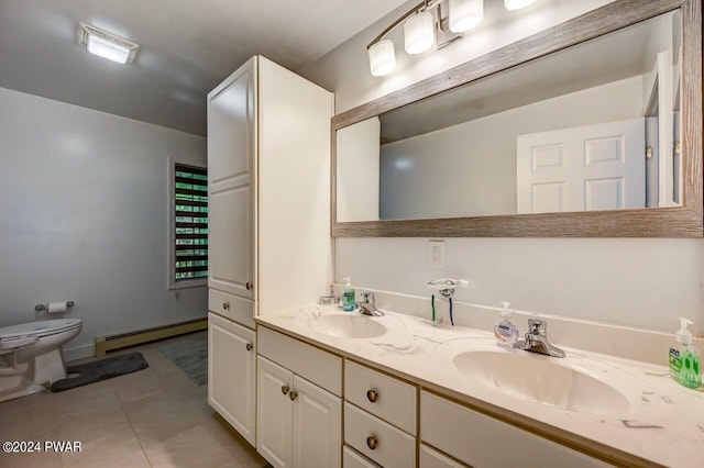 bathroom featuring toilet, vanity, tile patterned floors, and a baseboard heating unit