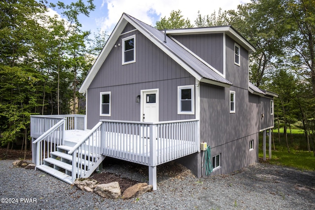 view of front facade with metal roof and a wooden deck