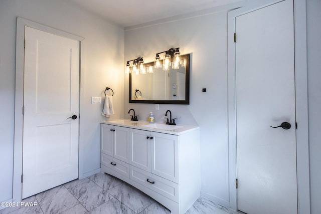 bathroom with marble finish floor, a sink, and double vanity