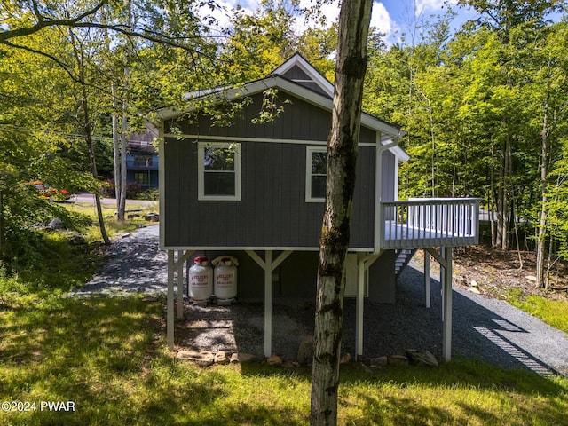 view of property exterior featuring a wooden deck