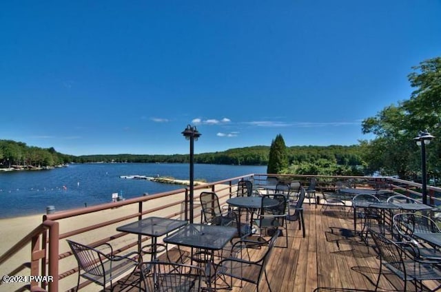 wooden terrace featuring a water view