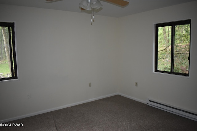 carpeted spare room with a baseboard radiator and ceiling fan