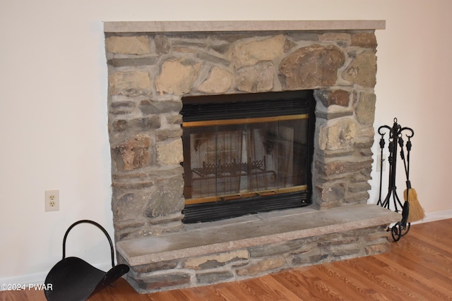 room details featuring a fireplace and wood-type flooring