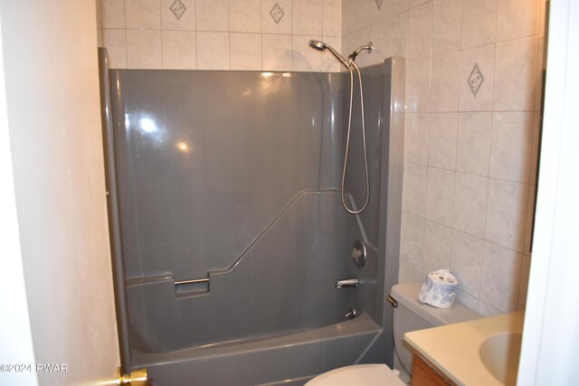 full bathroom featuring tile walls, vanity, shower / bathtub combination, and toilet