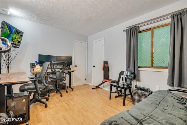 102 Keystone Ct, Dingmans Ferry, PA 18328 - bedroom featuring wood finished floors, a desk, and a textured ceiling