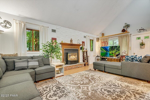 102 Keystone Ct, Dingmans Ferry, PA 18328 - living room with wood finished floors, high vaulted ceiling, and a textured ceiling