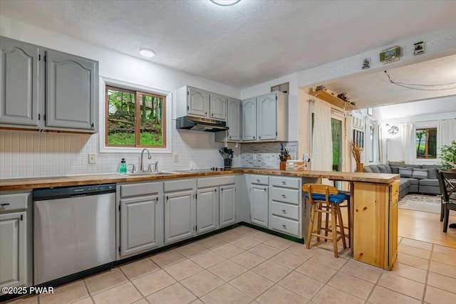 102 Keystone Ct, Dingmans Ferry, PA 18328 - kitchen featuring dishwasher, gray cabinetry, open floor plan, under cabinet range hood, and a textured ceiling