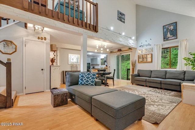 102 Keystone Ct, Dingmans Ferry, PA 18328 - living room featuring stairs, high vaulted ceiling, wood finished floors, and plenty of natural light