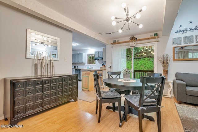 102 Keystone Ct, Dingmans Ferry, PA 18328 - dining space featuring a chandelier, light wood-type flooring, and a textured ceiling
