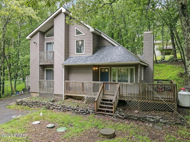 102 Keystone Ct, Dingmans Ferry, PA 18328 - view of front facade with a shingled roof, a chimney, and covered porch