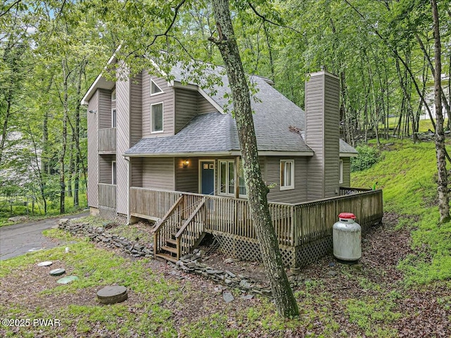 102 Keystone Ct, Dingmans Ferry, PA 18328 - view of front of property featuring roof with shingles, a chimney, and a porch