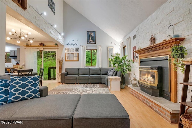 102 Keystone Ct, Dingmans Ferry, PA 18328 - living room featuring high vaulted ceiling, wood finished floors, and a chandelier