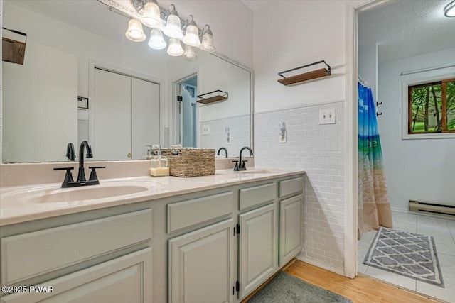 102 Keystone Ct, Dingmans Ferry, PA 18328 - full bath featuring double vanity, wood finished floors, a wainscoted wall, tile walls, and a shower with curtain