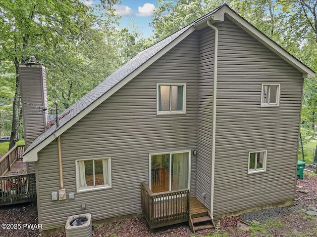 102 Keystone Ct, Dingmans Ferry, PA 18328 - rear view of house featuring a wooden deck and a chimney