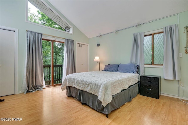 102 Keystone Ct, Dingmans Ferry, PA 18328 - bedroom with high vaulted ceiling, access to exterior, and light wood finished floors