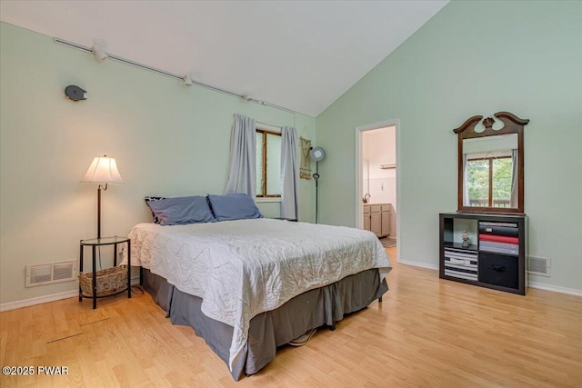 102 Keystone Ct, Dingmans Ferry, PA 18328 - bedroom with wood finished floors, multiple windows, high vaulted ceiling, and ensuite bath
