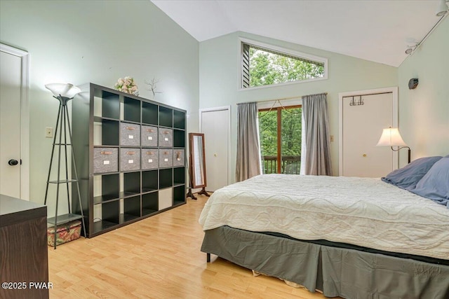 102 Keystone Ct, Dingmans Ferry, PA 18328 - bedroom with high vaulted ceiling, wood finished floors, and access to outside
