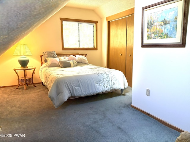 bedroom with vaulted ceiling, a closet, carpet floors, and baseboards