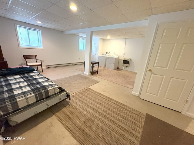 carpeted bedroom with independent washer and dryer, a baseboard heating unit, a paneled ceiling, baseboards, and heating unit