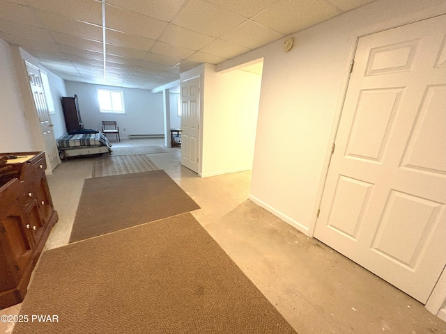 hallway featuring carpet, a paneled ceiling, and a baseboard radiator