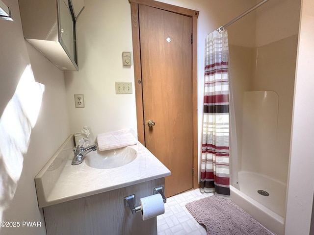 bathroom featuring a stall shower and vanity