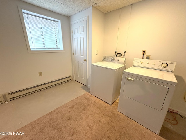 clothes washing area with baseboard heating, independent washer and dryer, and light carpet