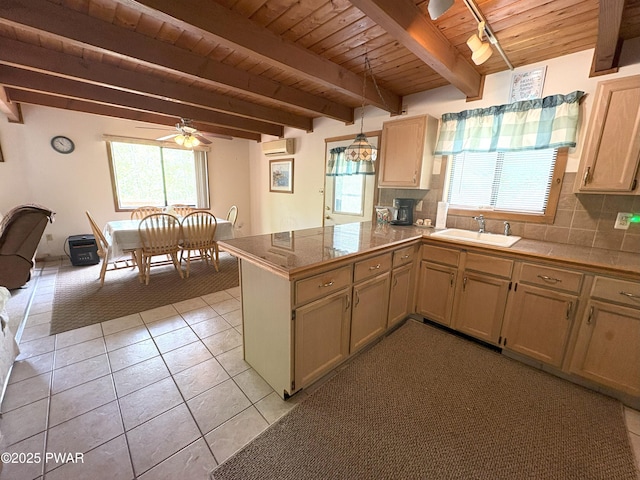 kitchen featuring wood ceiling, a sink, healthy amount of natural light, an AC wall unit, and a peninsula
