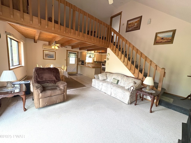 carpeted living room with ceiling fan and stairs