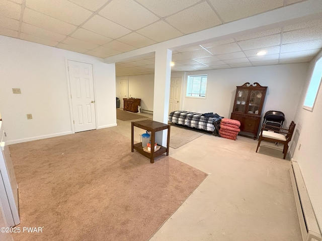 living area featuring a paneled ceiling, a baseboard heating unit, carpet flooring, and baseboards