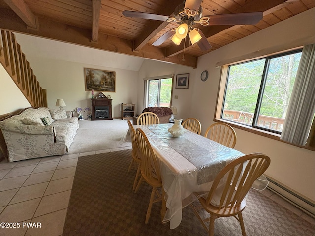 dining area with a baseboard radiator, wooden ceiling, light colored carpet, ceiling fan, and light tile patterned floors
