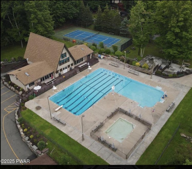 aerial view of property and surrounding area with a pool