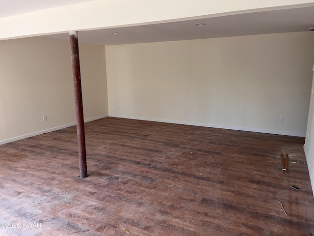 basement with dark hardwood / wood-style floors