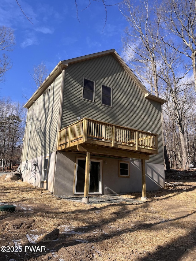 back of property featuring a wooden deck