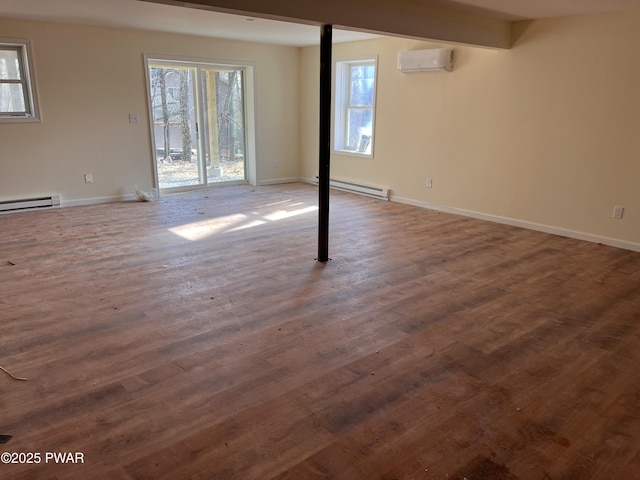 basement featuring a wall unit AC, dark hardwood / wood-style flooring, and a baseboard radiator