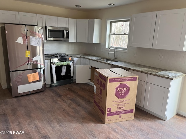 kitchen with white cabinets, stainless steel appliances, and sink