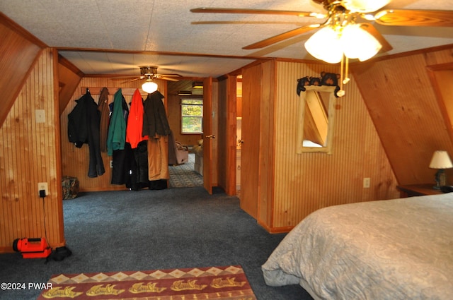 carpeted bedroom with ceiling fan and wooden walls