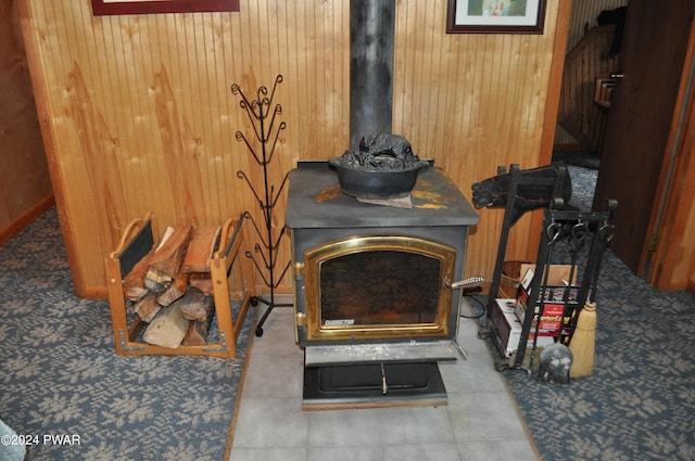 interior details with wood walls and a wood stove