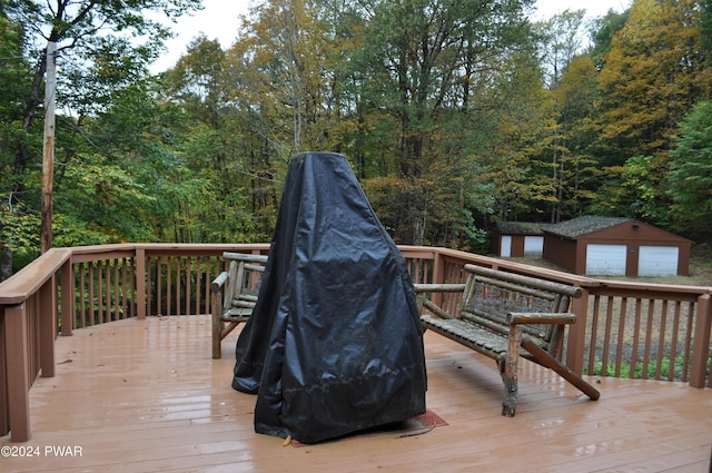 deck with an outdoor structure and a wooded view