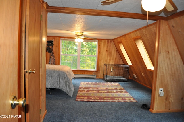 carpeted bedroom with wood walls, a baseboard heating unit, and a ceiling fan