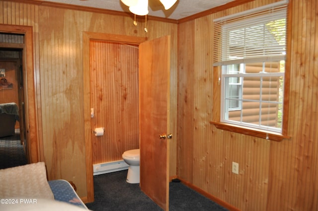 bathroom with ornamental molding, a baseboard radiator, a healthy amount of sunlight, and toilet