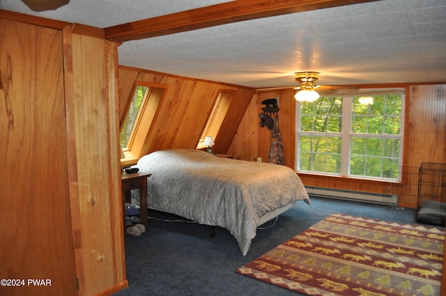 carpeted bedroom with a baseboard radiator, wooden walls, and ceiling fan