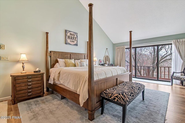 113 Marina Village Ln, Greentown, PA 18426 - bedroom featuring high vaulted ceiling, access to exterior, baseboards, and wood finished floors