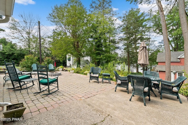 view of patio with outdoor dining area and an outdoor fire pit