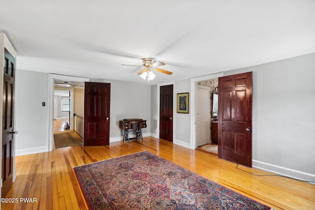 interior space featuring baseboards and light wood-type flooring