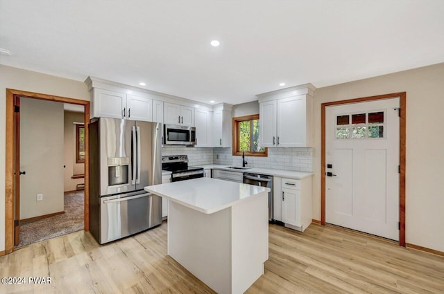 kitchen featuring white cabinetry, sink, a center island, and stainless steel appliances