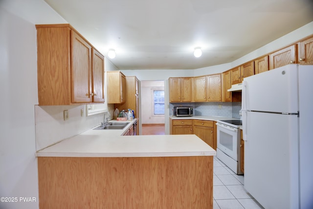 3122 Sparrow Ct, East Stroudsburg, PA 18302 - kitchen with white appliances, under cabinet range hood, tasteful backsplash, and light countertops