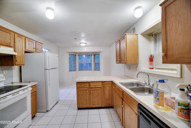 3122 Sparrow Ct, East Stroudsburg, PA 18302 - kitchen with white appliances, under cabinet range hood, light tile patterned floors, light countertops, and a peninsula