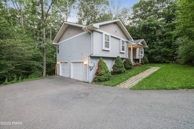 3122 Sparrow Ct, East Stroudsburg, PA 18302 - view of home's exterior featuring asphalt driveway, an attached garage, and a lawn