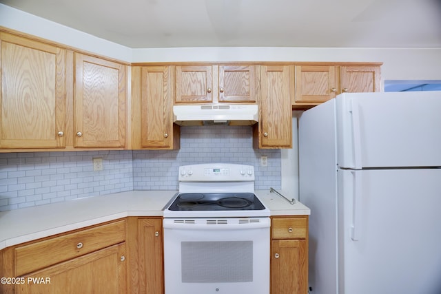 3122 Sparrow Ct, East Stroudsburg, PA 18302 - kitchen with white appliances, under cabinet range hood, light countertops, and decorative backsplash